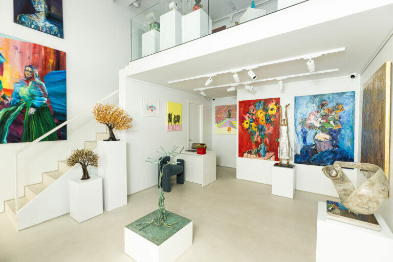 View of the ground floor of the gallery. Paintings and sculptures can be seen.